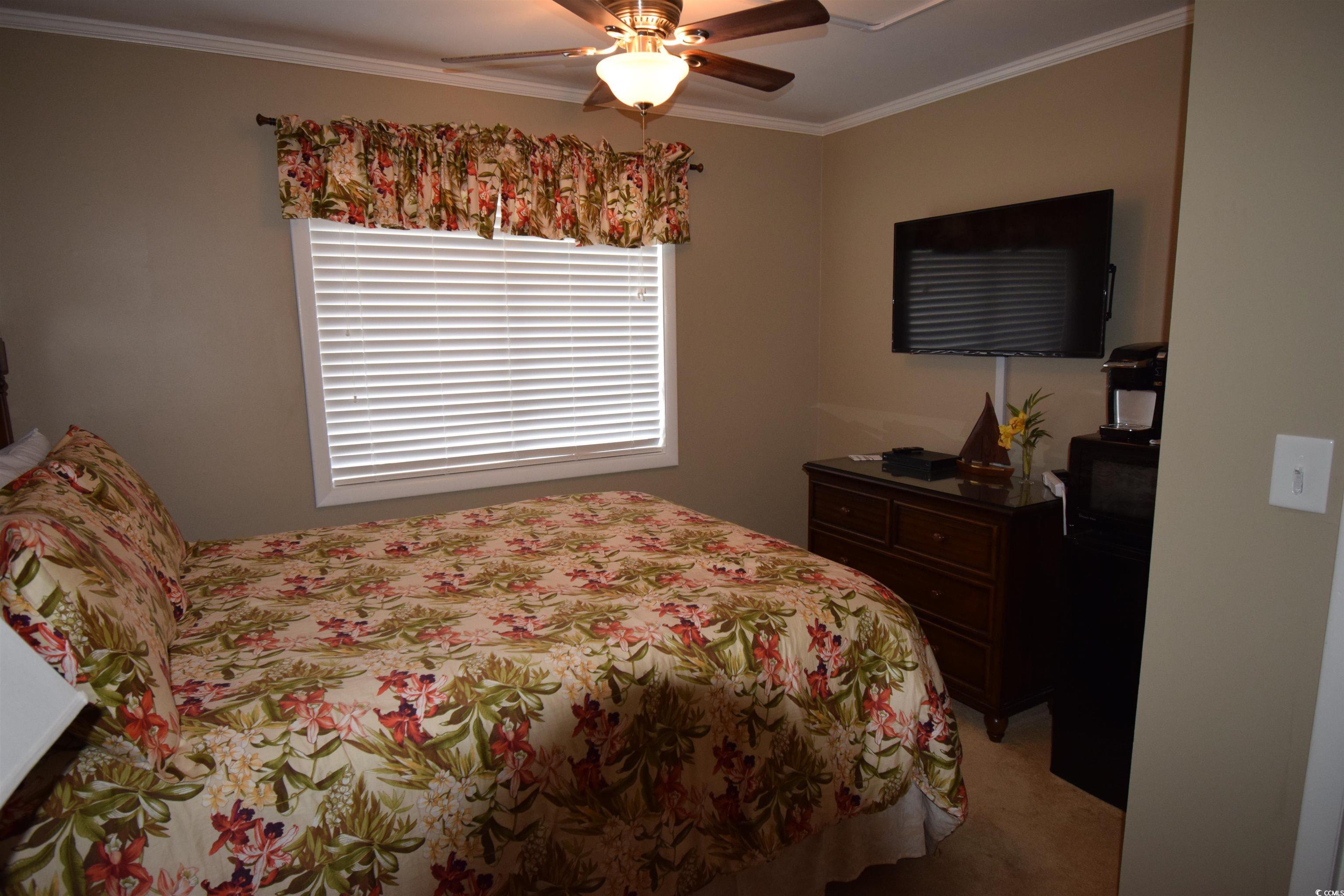 Image 3: Bedroom featuring crown molding, light colored car Image 3: Bedroom featuring crown molding, light colored car
