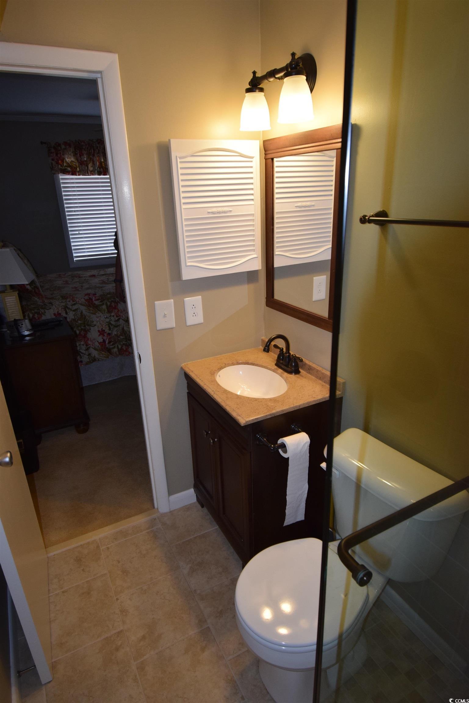 Image 4: Bathroom featuring vanity and light tile patterned Image 4: Bathroom featuring vanity and light tile patterned