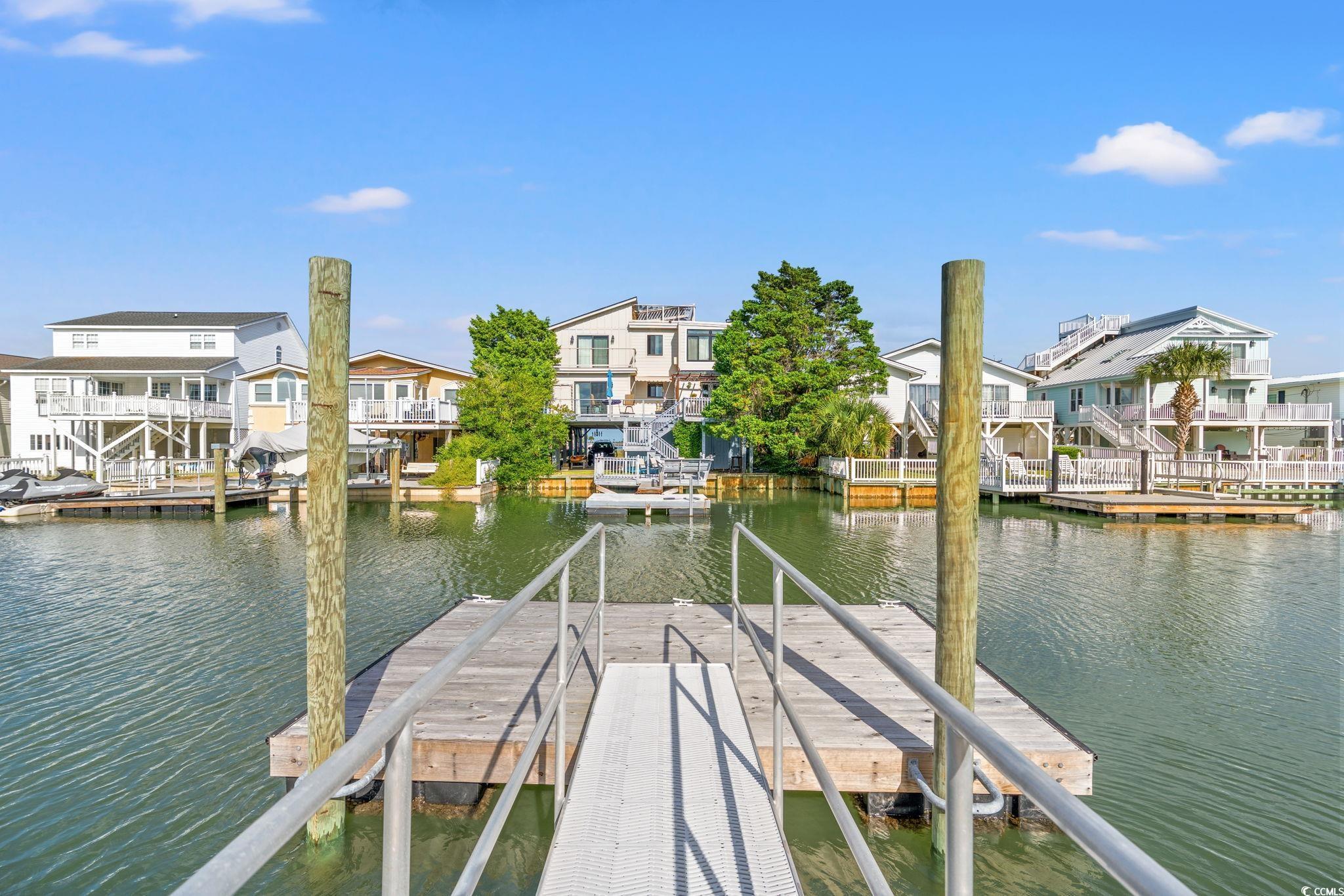 Image 2: Canal in rear yard with boat dock built in 2024. Image 2: Canal in rear yard with boat dock built in 2024.