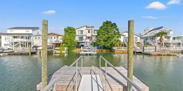 Image 2: Canal in rear yard with boat dock built in 2024. Image 2: Canal in rear yard with boat dock built in 2024.