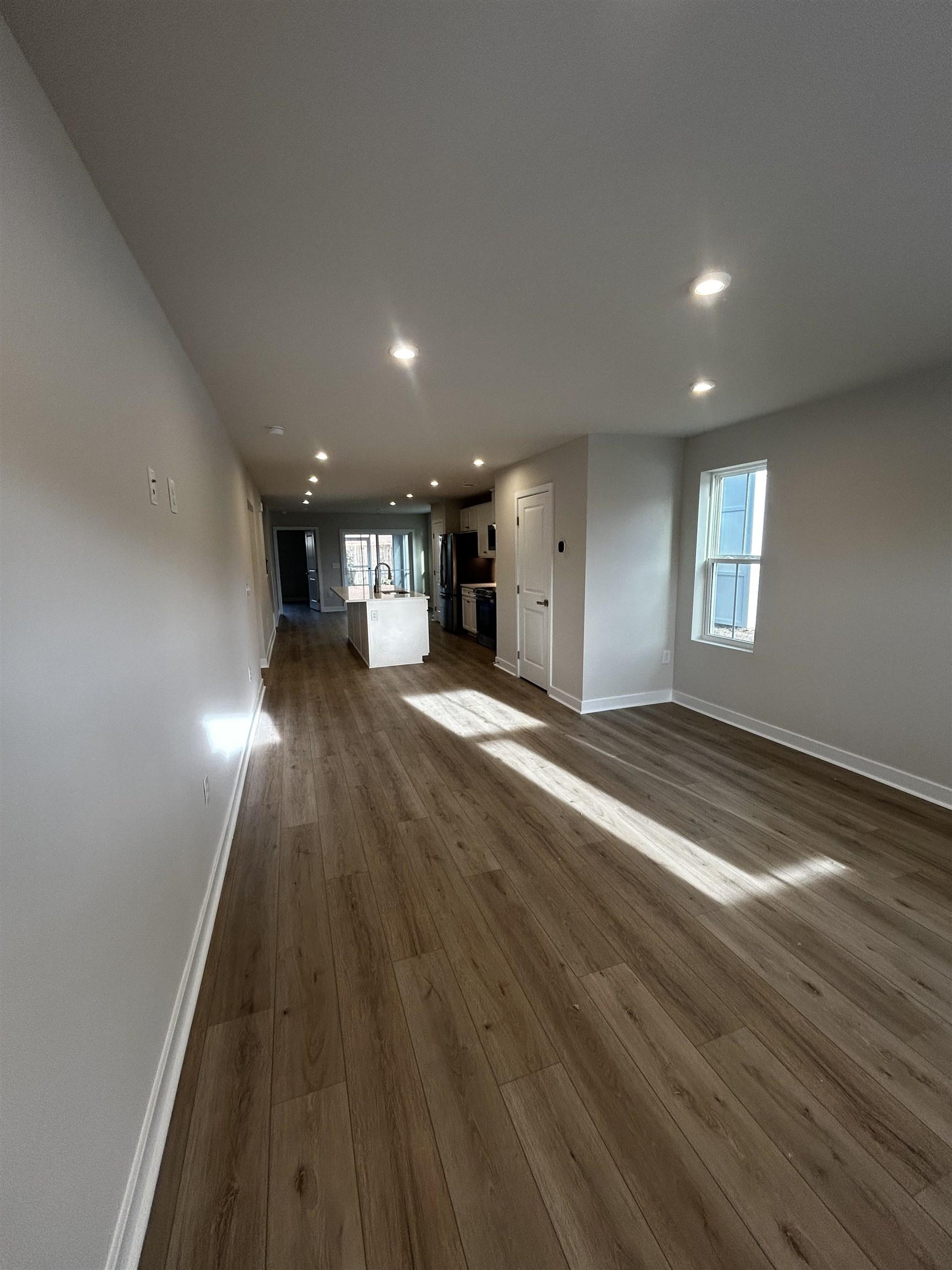 Image 2: Unfurnished living room with dark wood-style floor Image 2: Unfurnished living room with dark wood-style floor