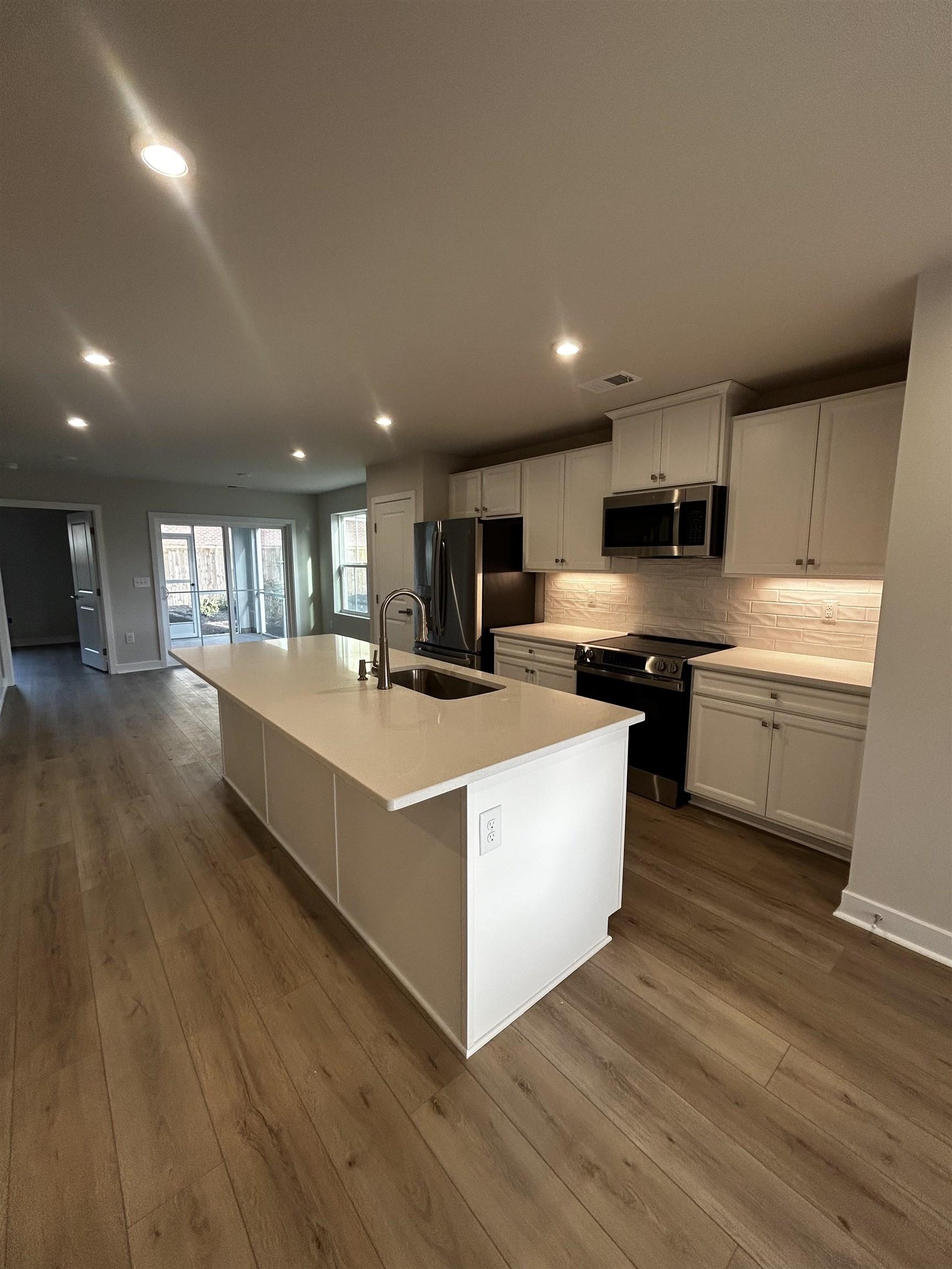 Image 3: Kitchen featuring a center island with sink, elect Image 3: Kitchen featuring a center island with sink, elect