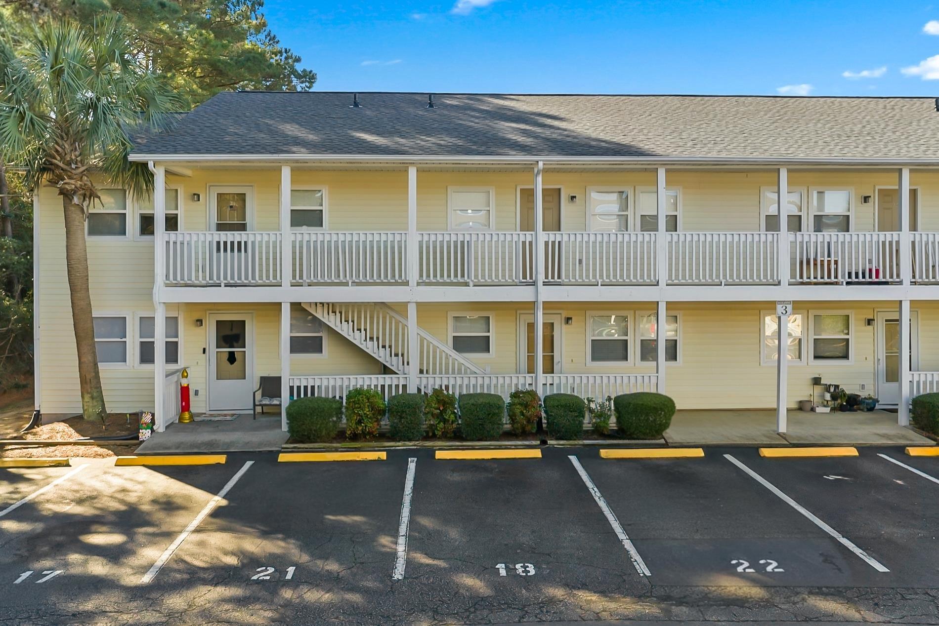 Image 1: View of property featuring uncovered parking