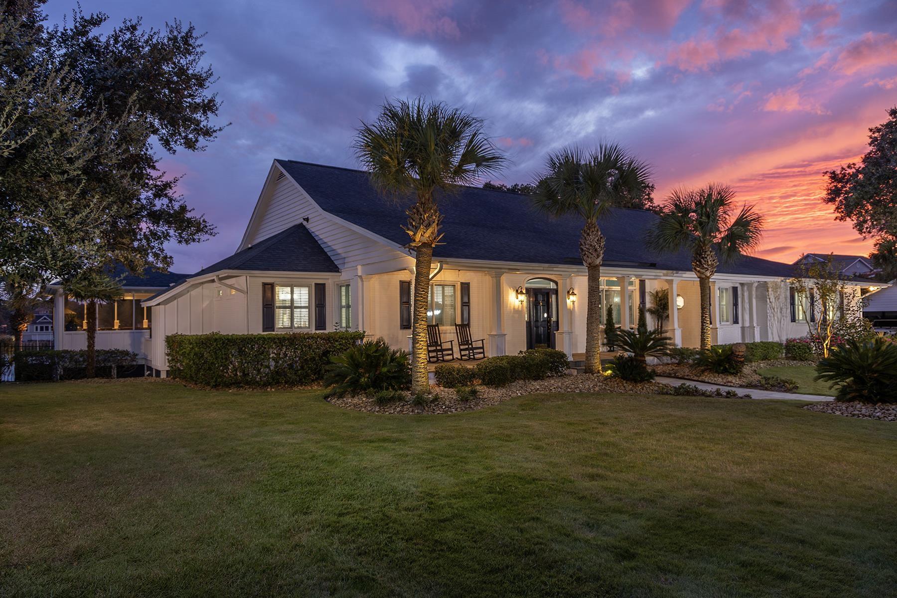 Image 1: Ranch-style home with covered porch and a yard