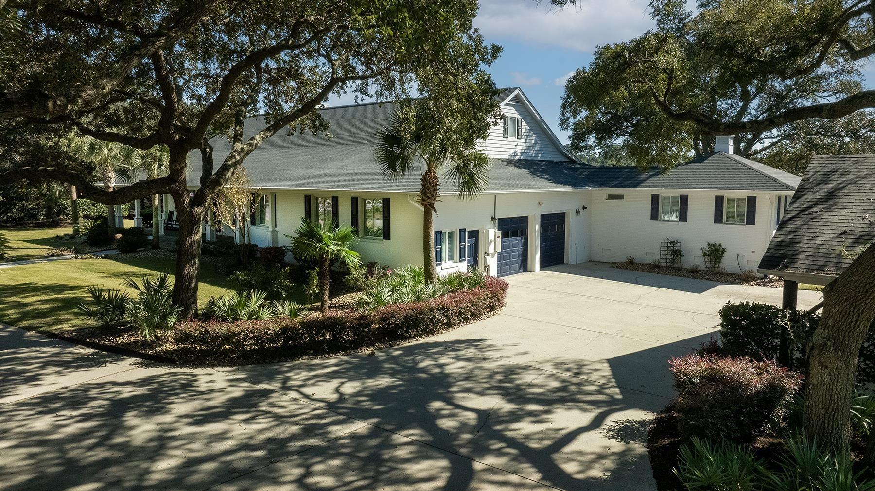 Image 4: View of front facade featuring driveway, stucco si