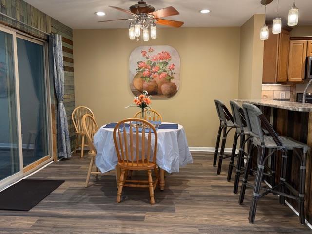 Image 4: Dining area featuring ceiling fan, dark wood finis