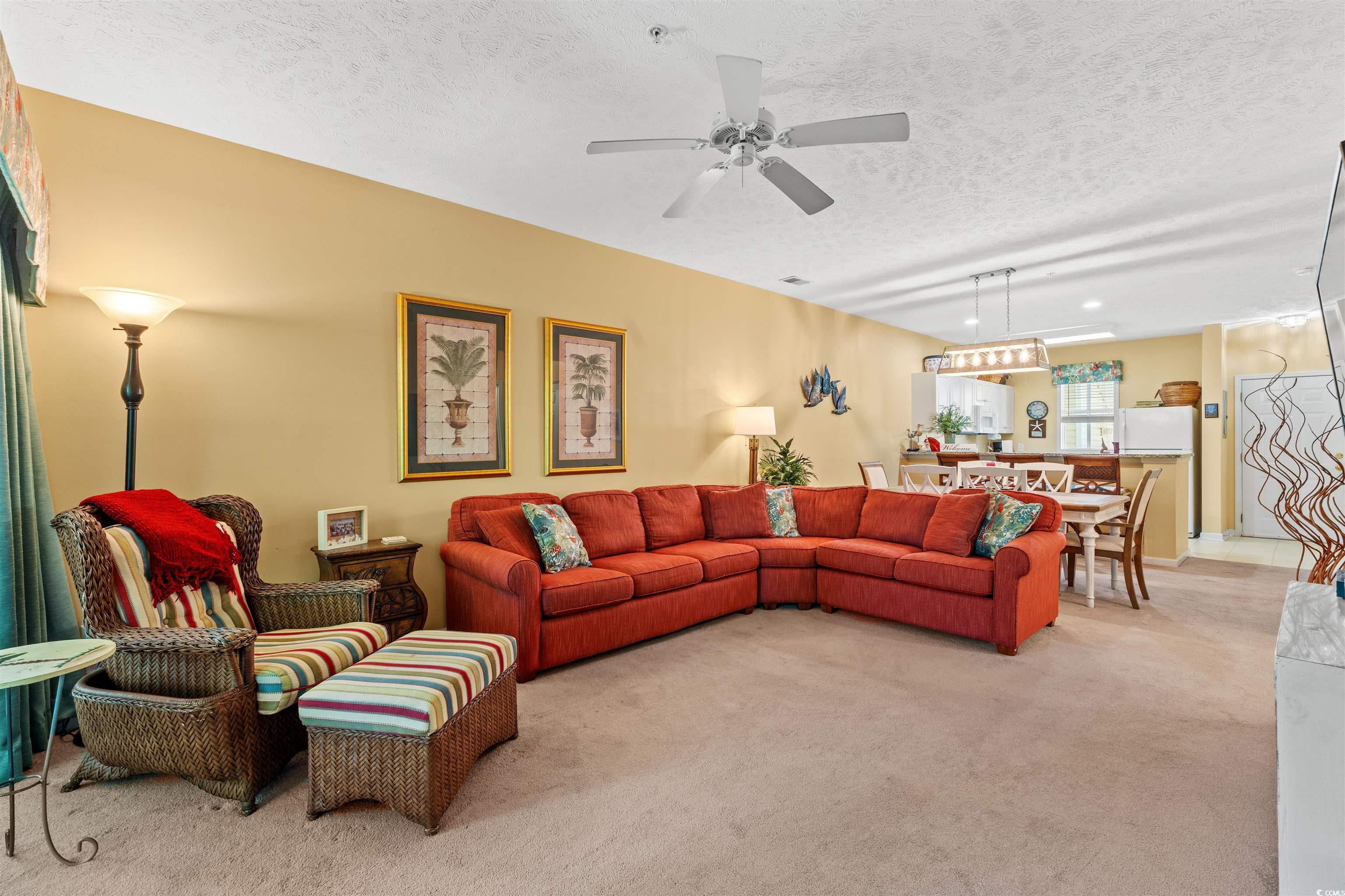 Image 3: Living area featuring light carpet, a textured cei Image 3: Living area featuring light carpet, a textured cei