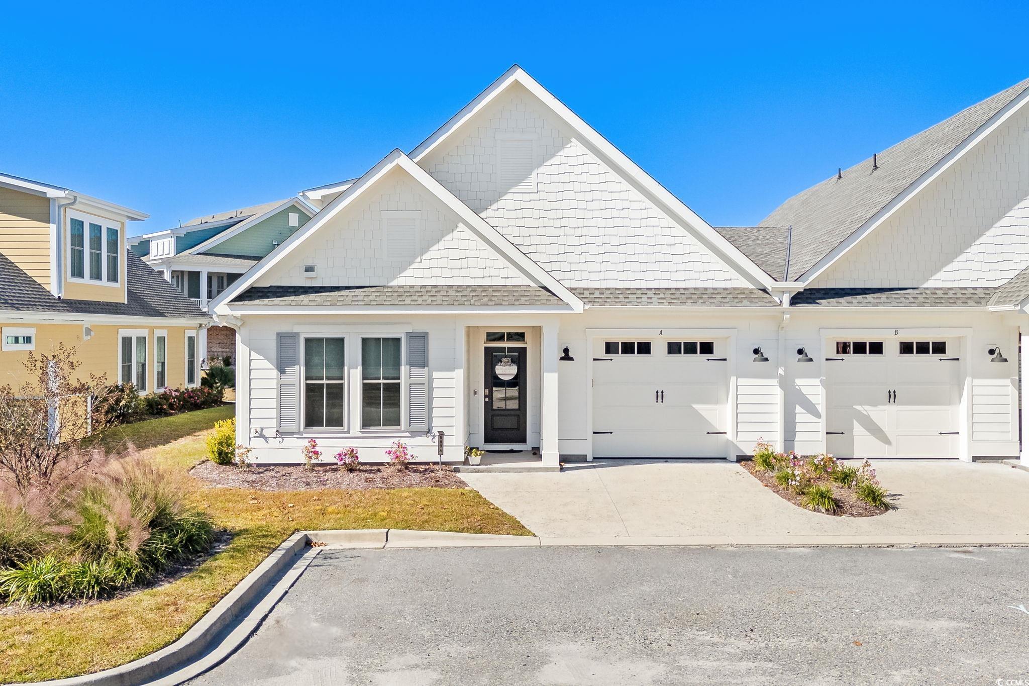 Image 1: Craftsman house with a shingled roof, concrete dri Image 1: Craftsman house with a shingled roof, concrete dri