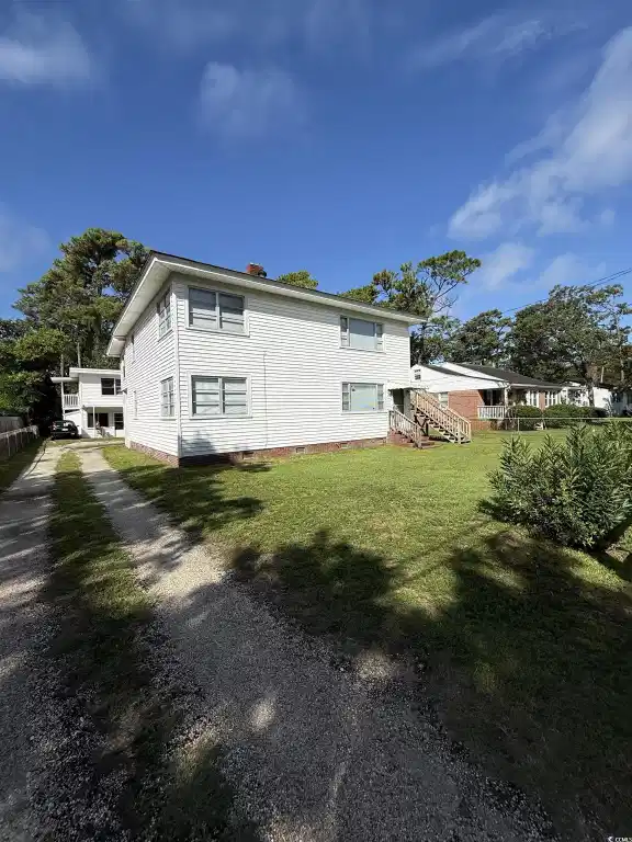 Image 1: View of property exterior featuring a chimney and