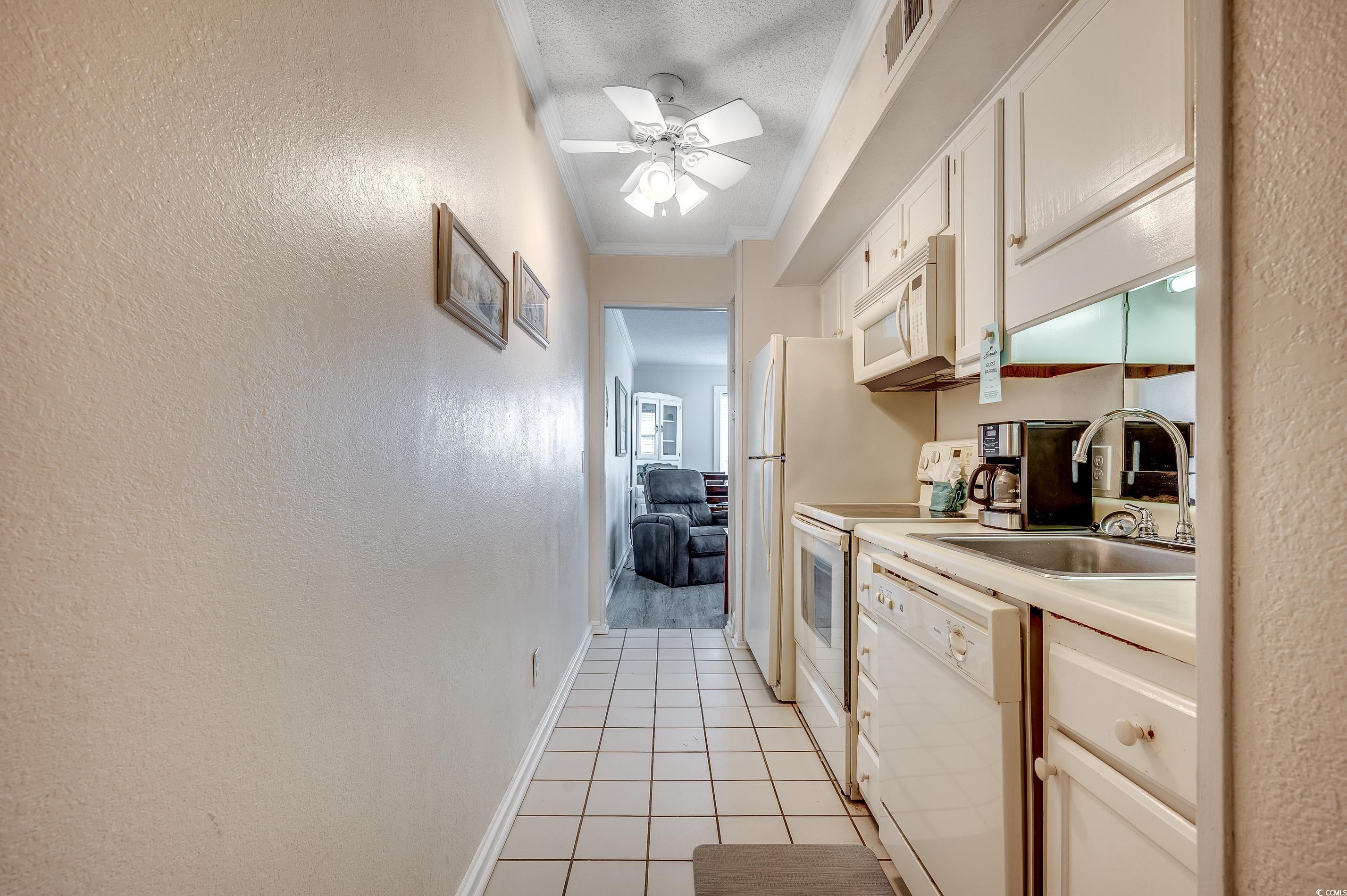 Image 3: Kitchen featuring visible vents, white appliances,