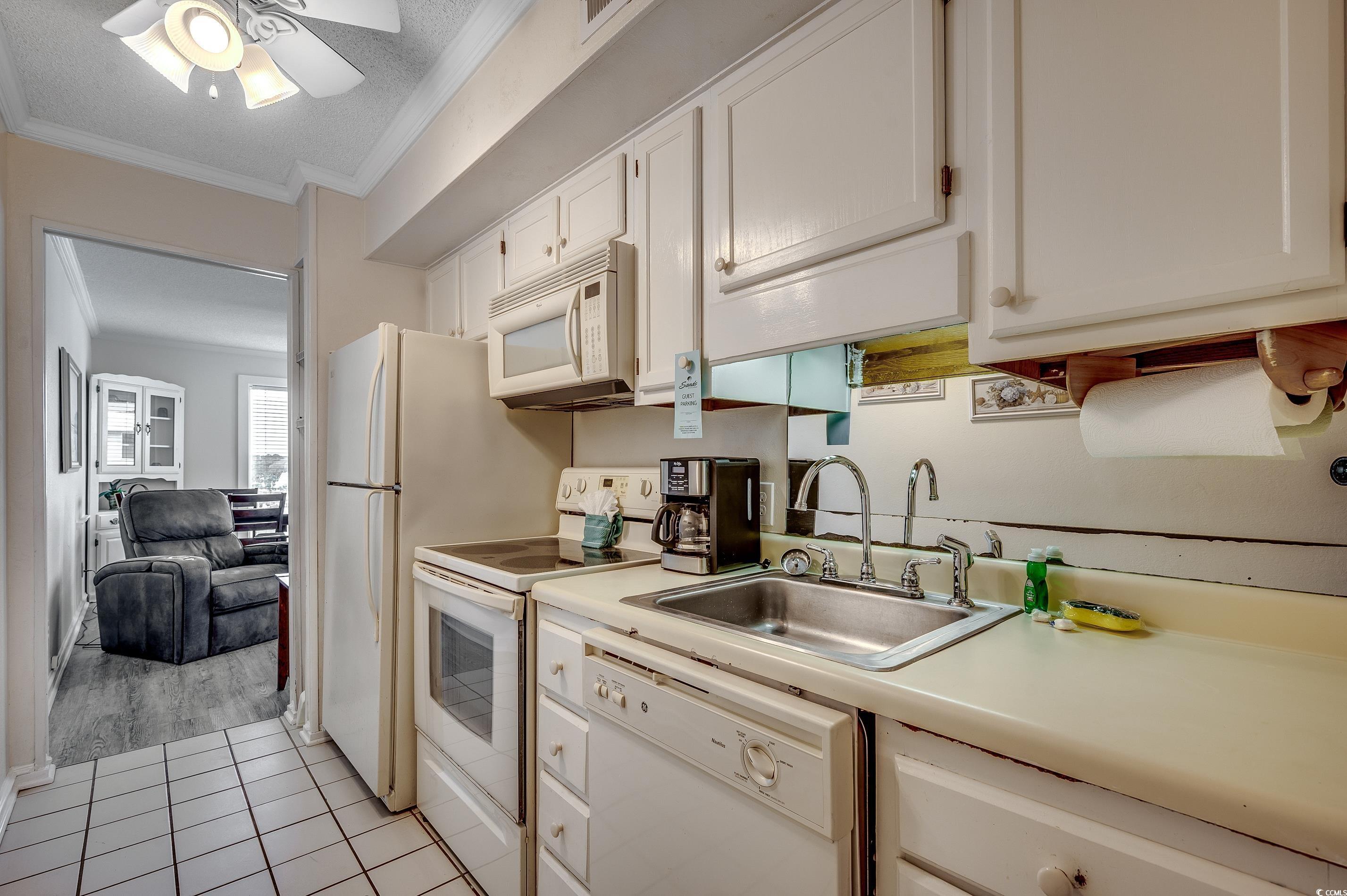 Image 4: Kitchen featuring light countertops, white applian
