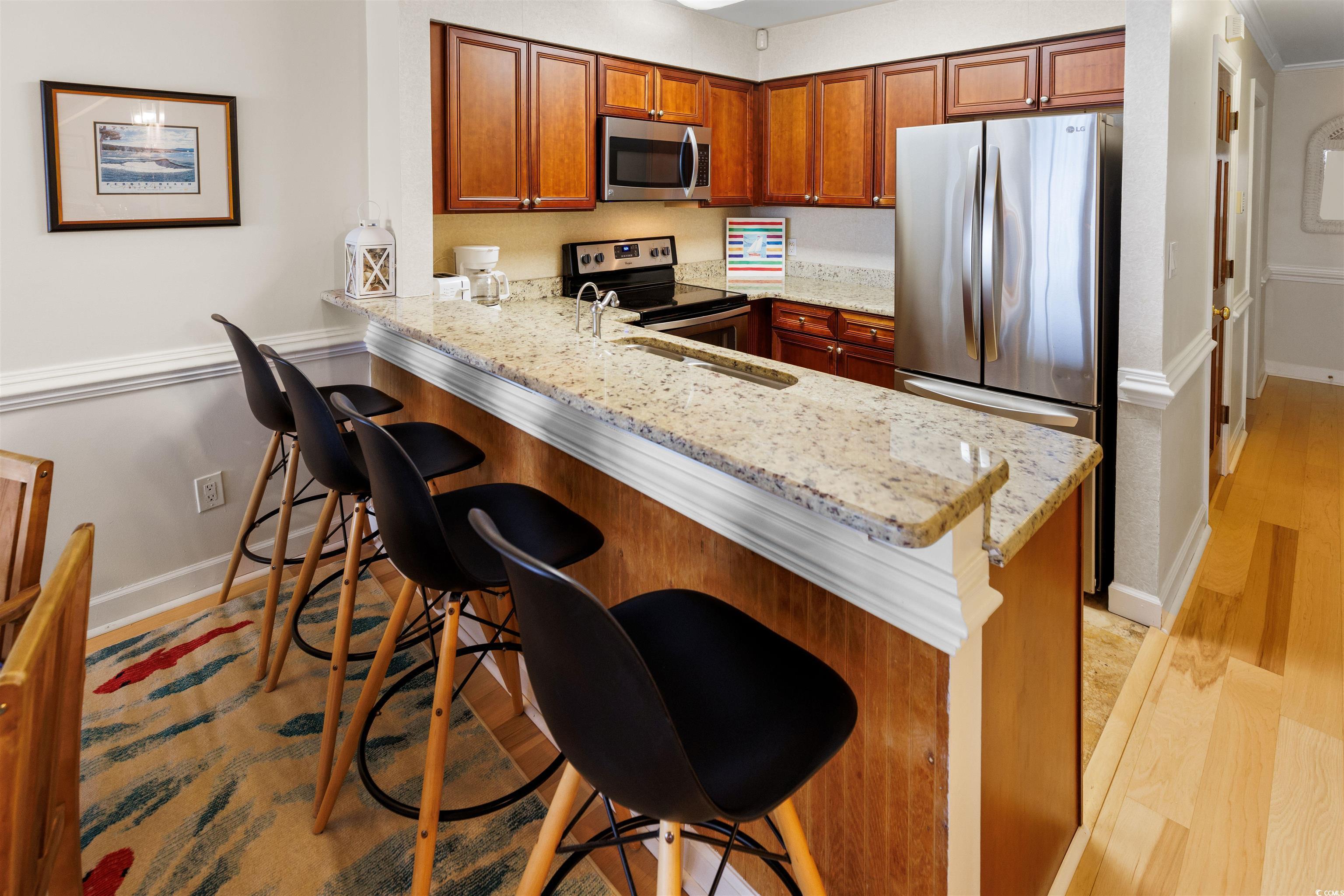 Image 3: Kitchen featuring a breakfast bar, appliances with Image 3: Kitchen featuring a breakfast bar, appliances with