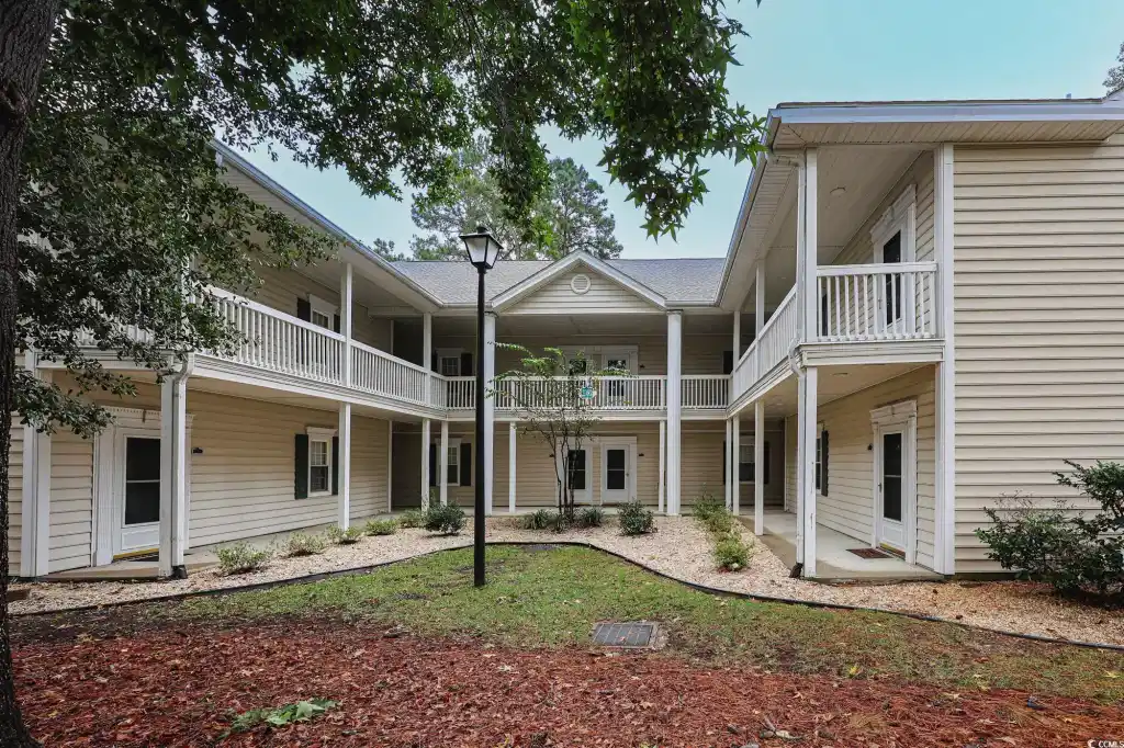 Image 1: Back of house with a patio area and a balcony Image 1: Back of house with a patio area and a balcony
