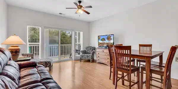 Image 3: Living area with light wood finished floors and a