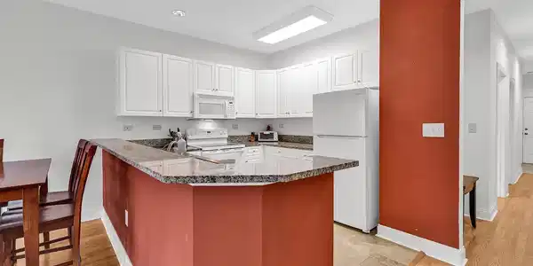 Image 4: Kitchen featuring white appliances, a peninsula, w
