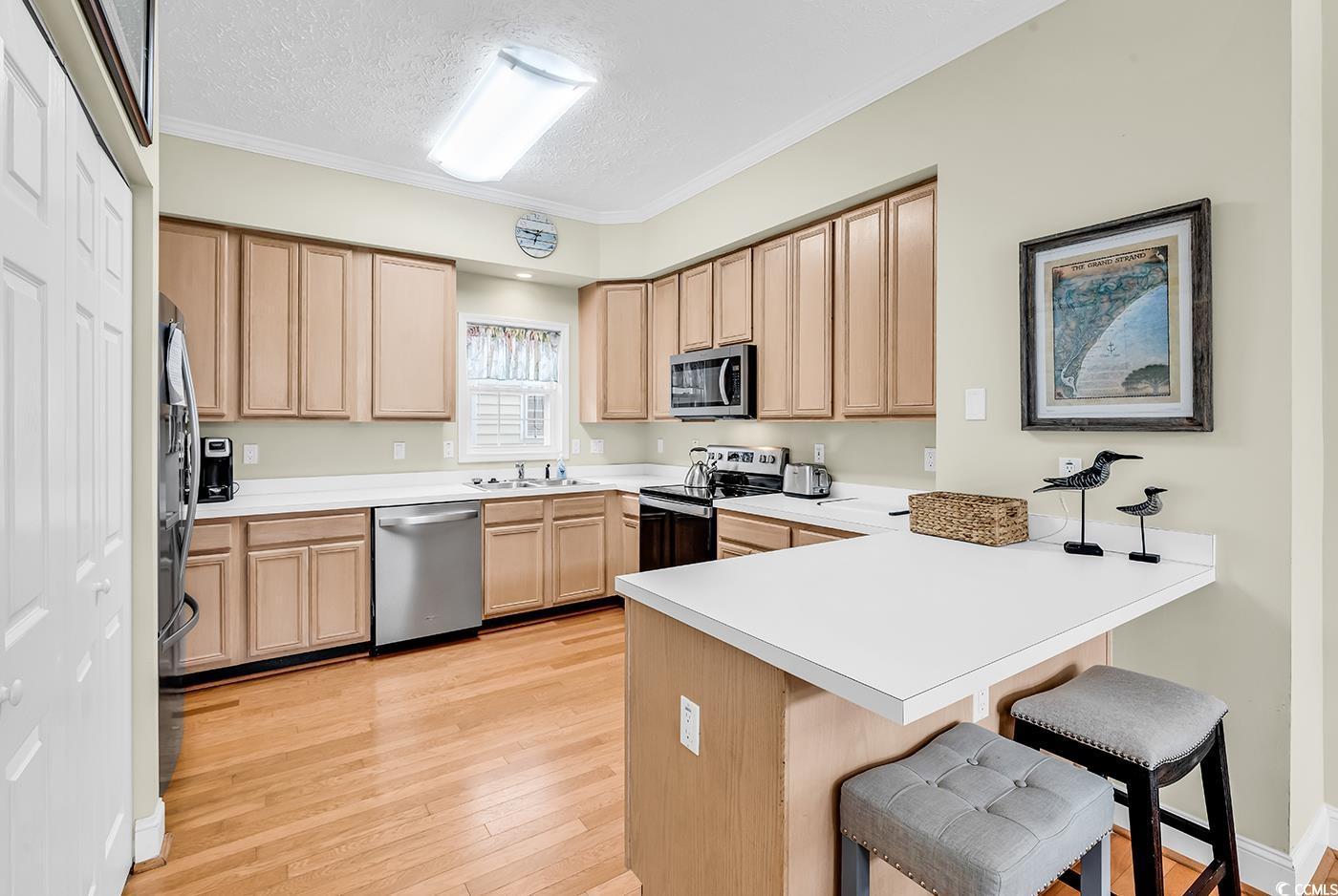 Image 3: Kitchen featuring stainless steel appliances, a pe