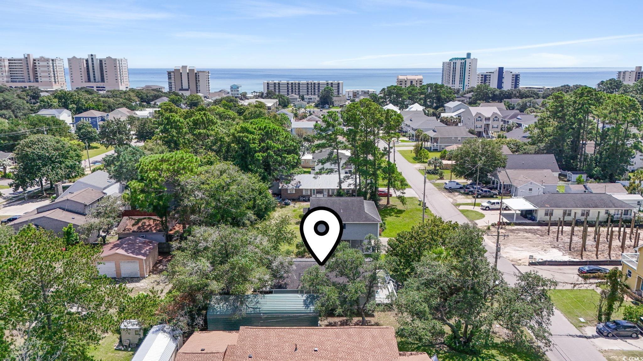 Image 2: Aerial view of residential area featuring a nearby