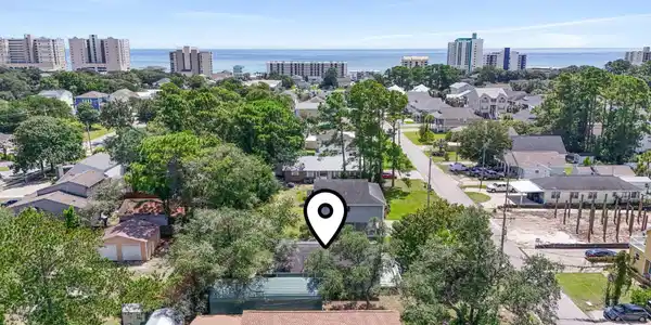 Image 2: Aerial view of residential area featuring a nearby