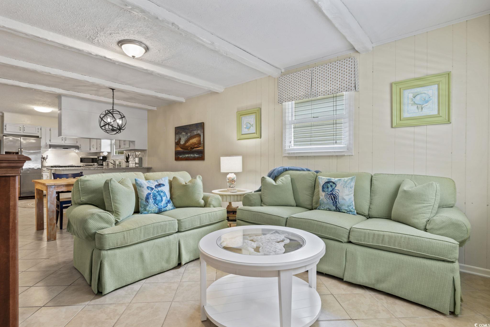 Image 3: Living area featuring light tile patterned floorin