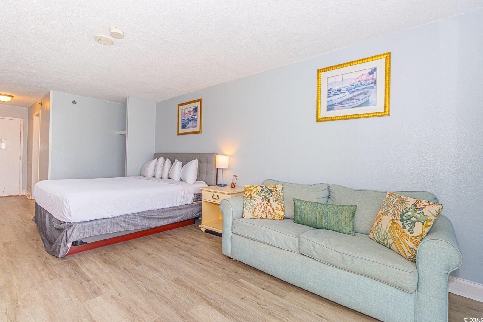 Image 4: Bedroom featuring wood finished floors and a textu