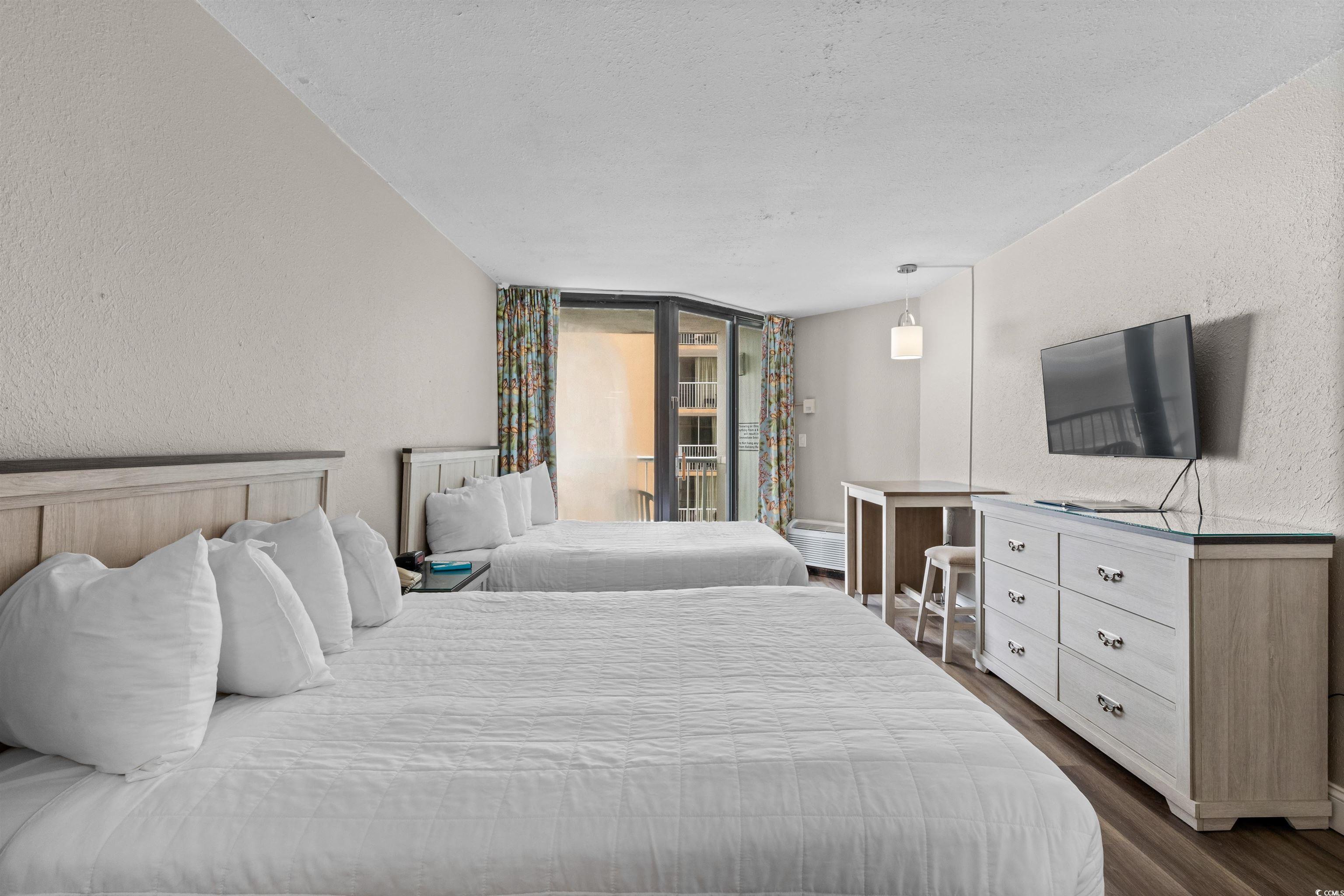 Image 4: Bedroom featuring a textured wall, dark wood finis