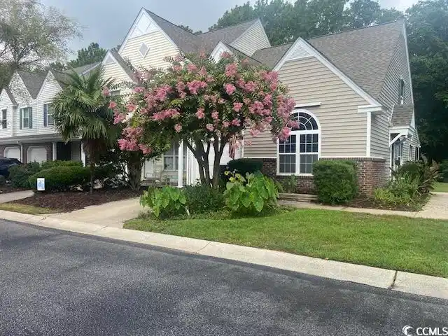 Image 1: Obstructed view of property featuring brick siding