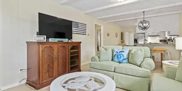 Image 4: Living room featuring beam ceiling and light tile