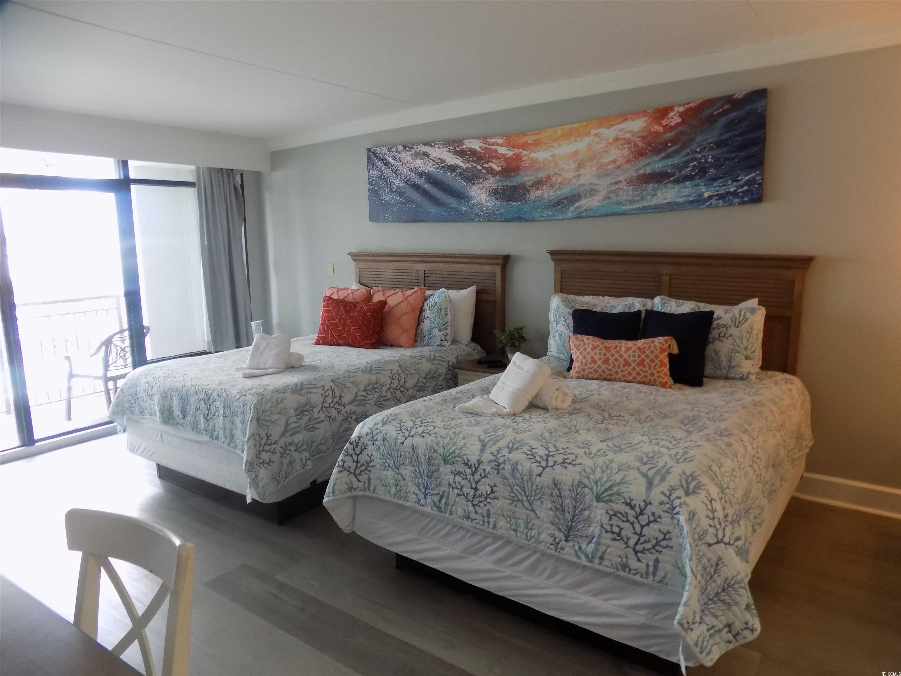 Image 2: Bedroom with wood finished floors and access to ou Image 2: Bedroom with wood finished floors and access to ou