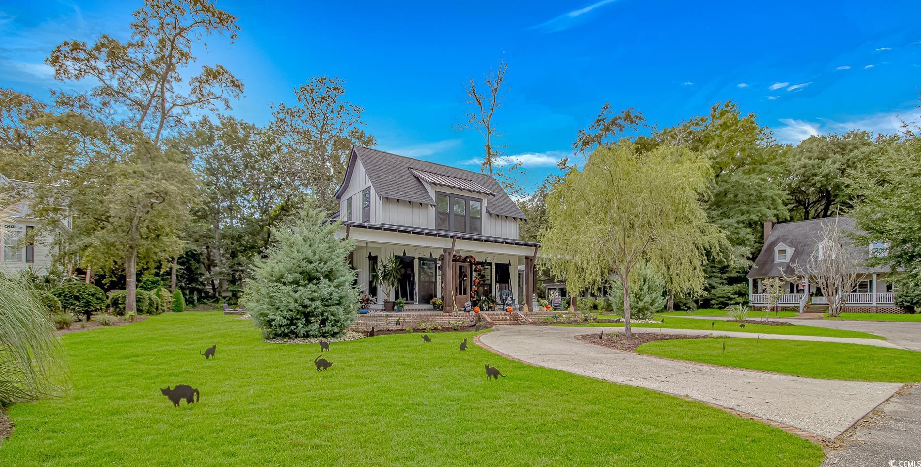 Image 2: View of front facade featuring covered porch, a fr Image 2: View of front facade featuring covered porch, a fr