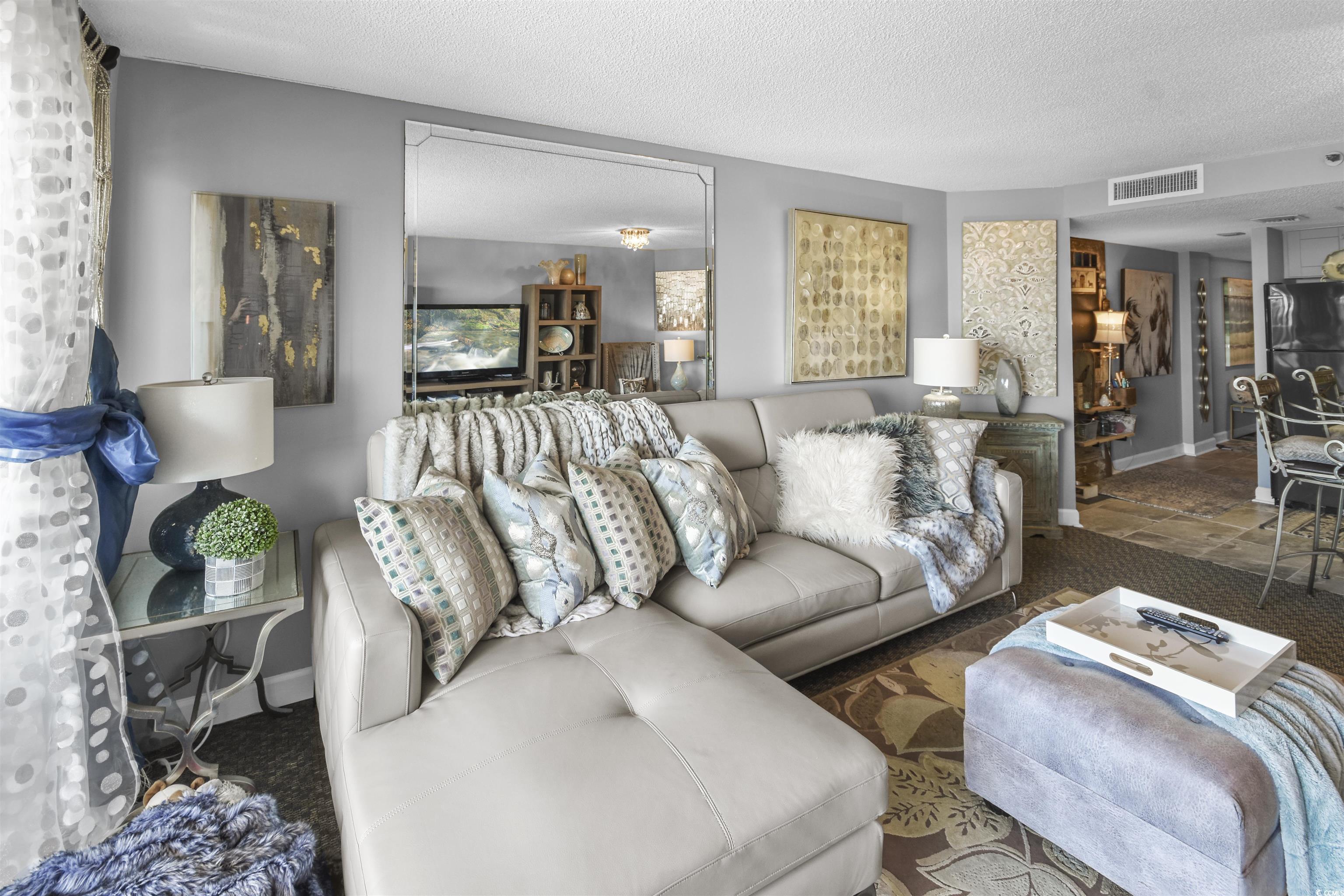 Image 4: Living room featuring visible vents, baseboards, a