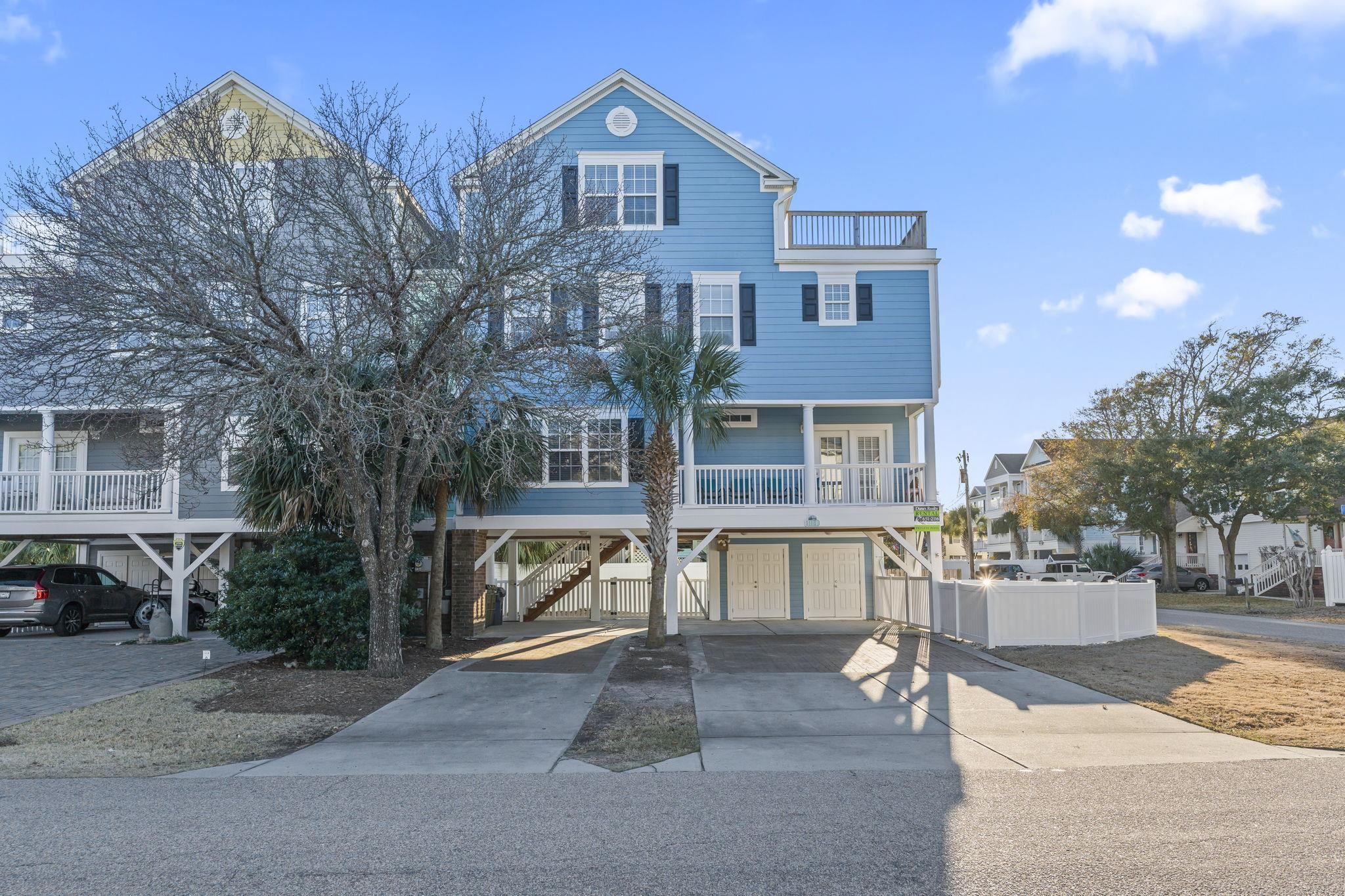 Image 2: Coastal home featuring a carport, stairway, and co Image 2: Coastal home featuring a carport, stairway, and co