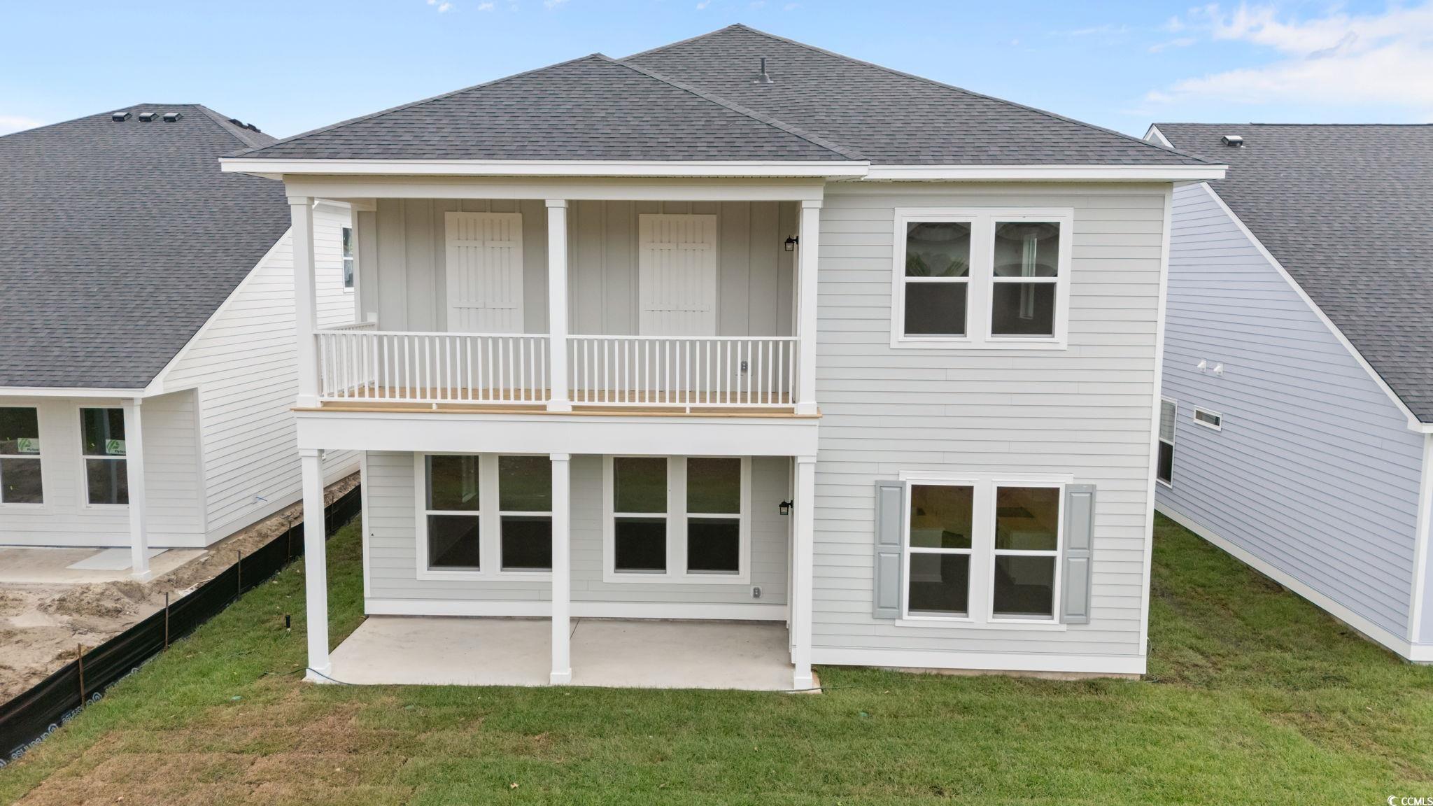Image 4: Rear view of property featuring a shingled roof, a