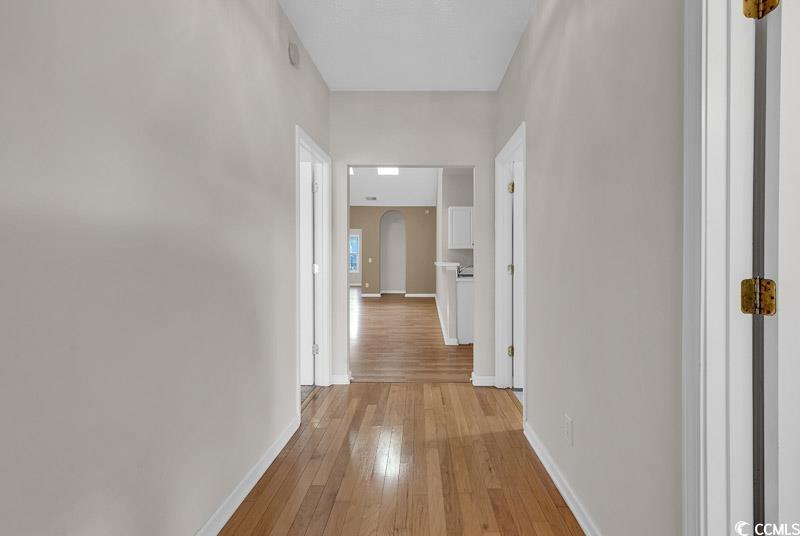 Image 2: Hallway with light hardwood / wood-style flooring