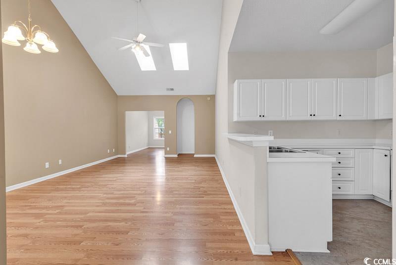 Image 3: Kitchen featuring white cabinets, ceiling fan with