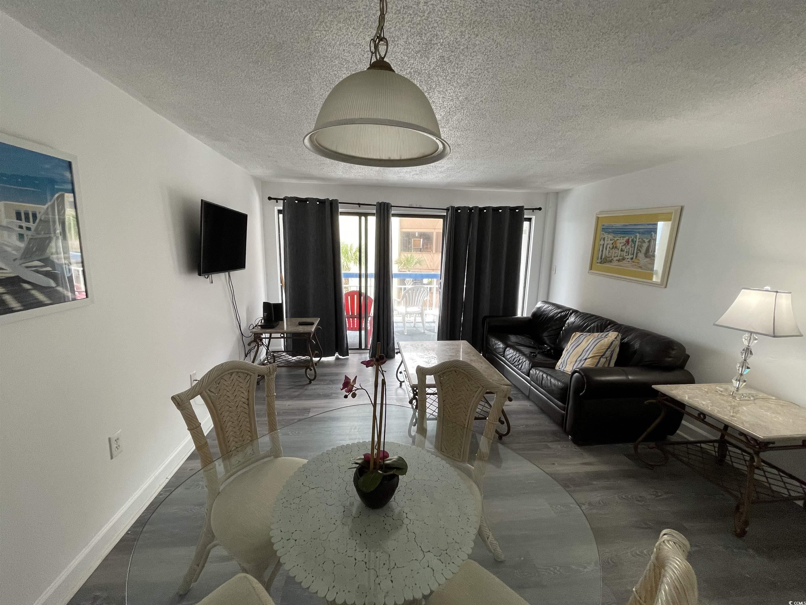 Image 3: Dining area featuring a textured ceiling