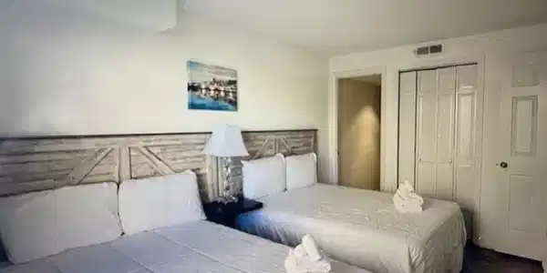 Image 4: Bedroom with visible vents, a closet, and wood fin Image 4: Bedroom with visible vents, a closet, and wood fin