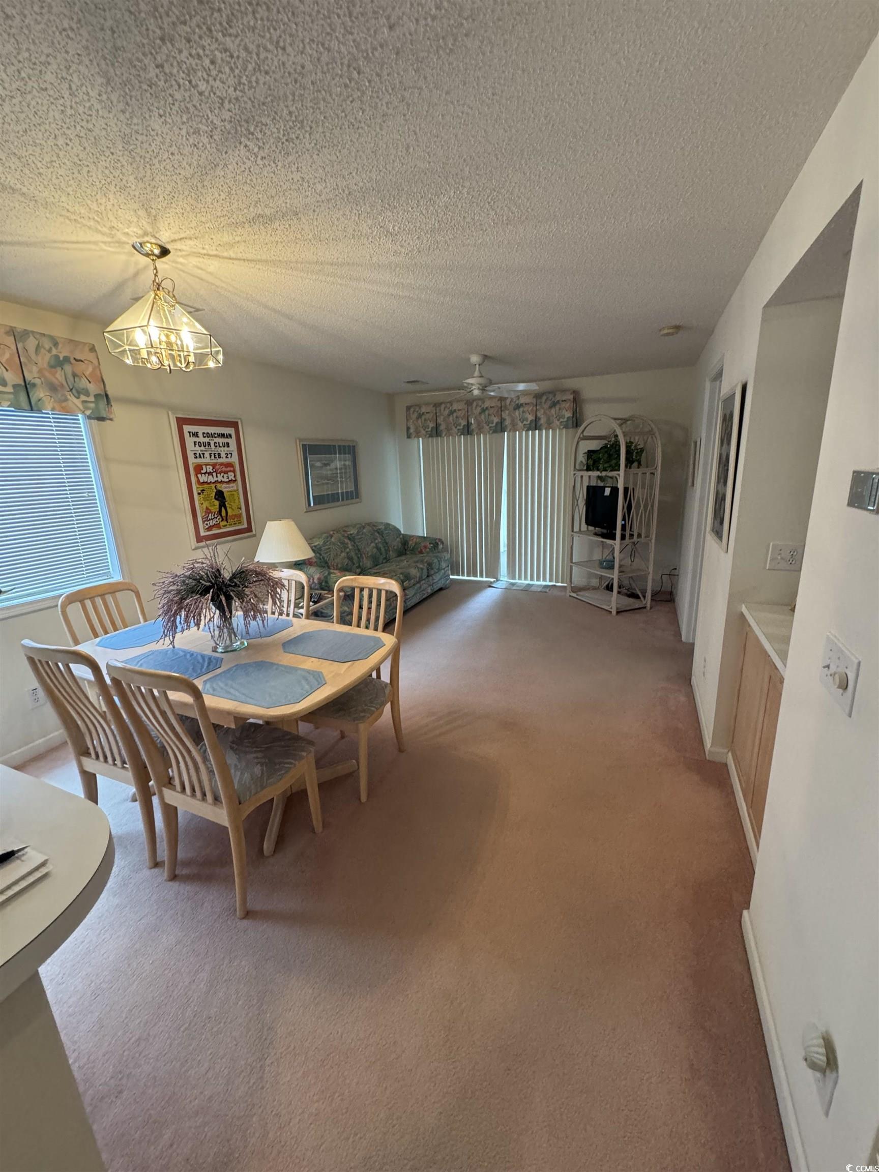 Image 2: Dining area with a textured ceiling, carpet floori Image 2: Dining area with a textured ceiling, carpet floori