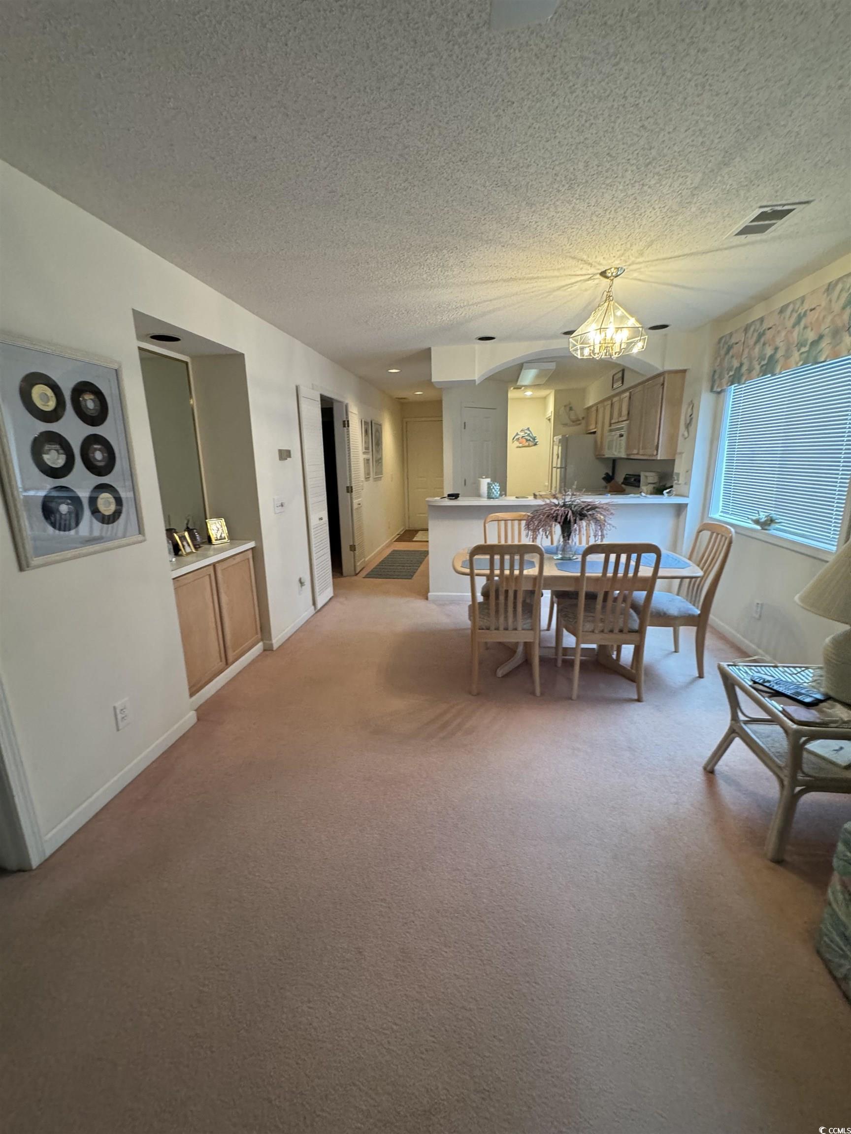 Image 3: Dining space with a textured ceiling, light colore Image 3: Dining space with a textured ceiling, light colore