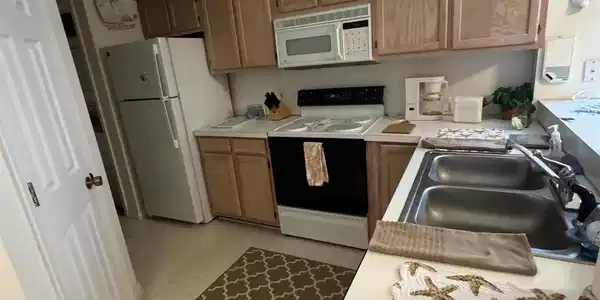 Image 4: Kitchen featuring light countertops, white applian