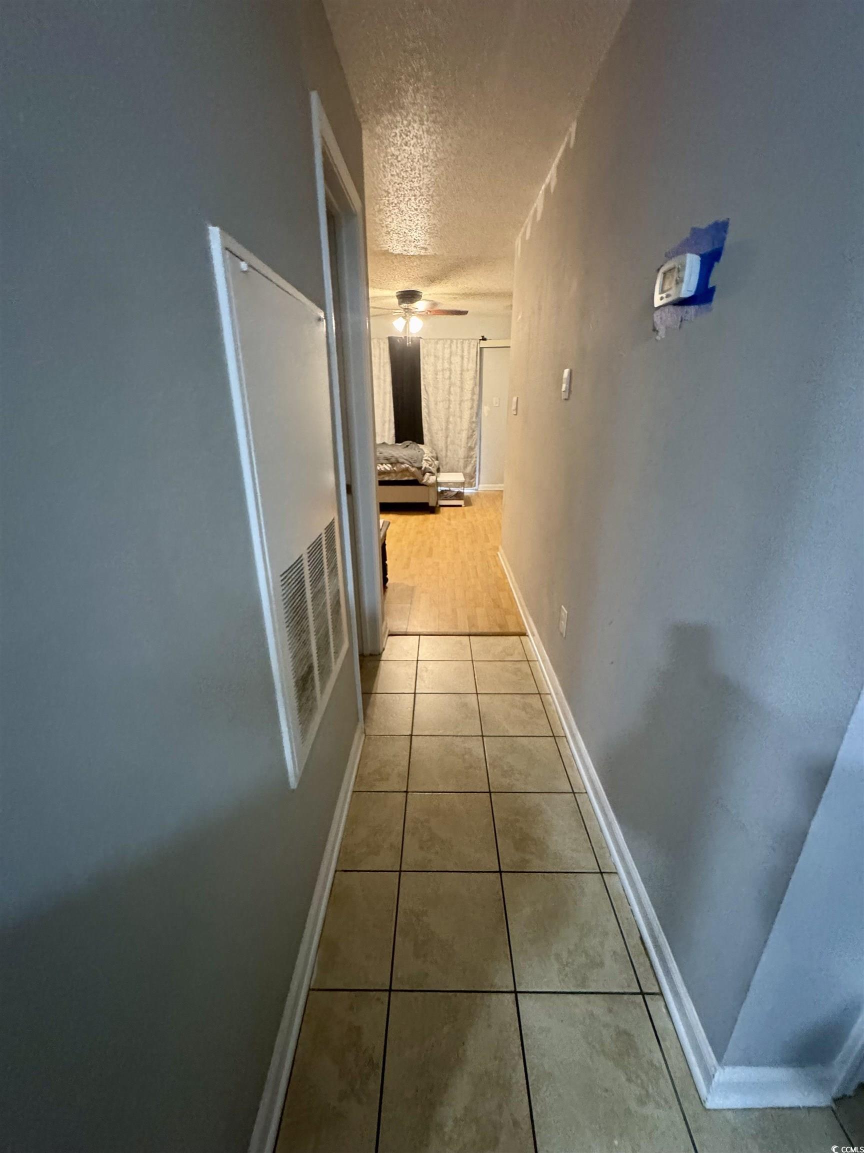 Image 4: Hall with a textured ceiling and light tile patter Image 4: Hall with a textured ceiling and light tile patter