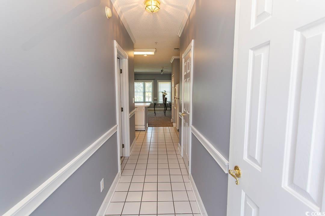 Image 2: Hallway with baseboards and light tile patterned f Image 2: Hallway with baseboards and light tile patterned f