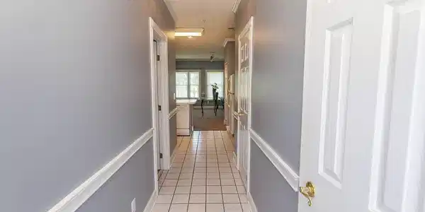 Image 2: Hallway with baseboards and light tile patterned f Image 2: Hallway with baseboards and light tile patterned f