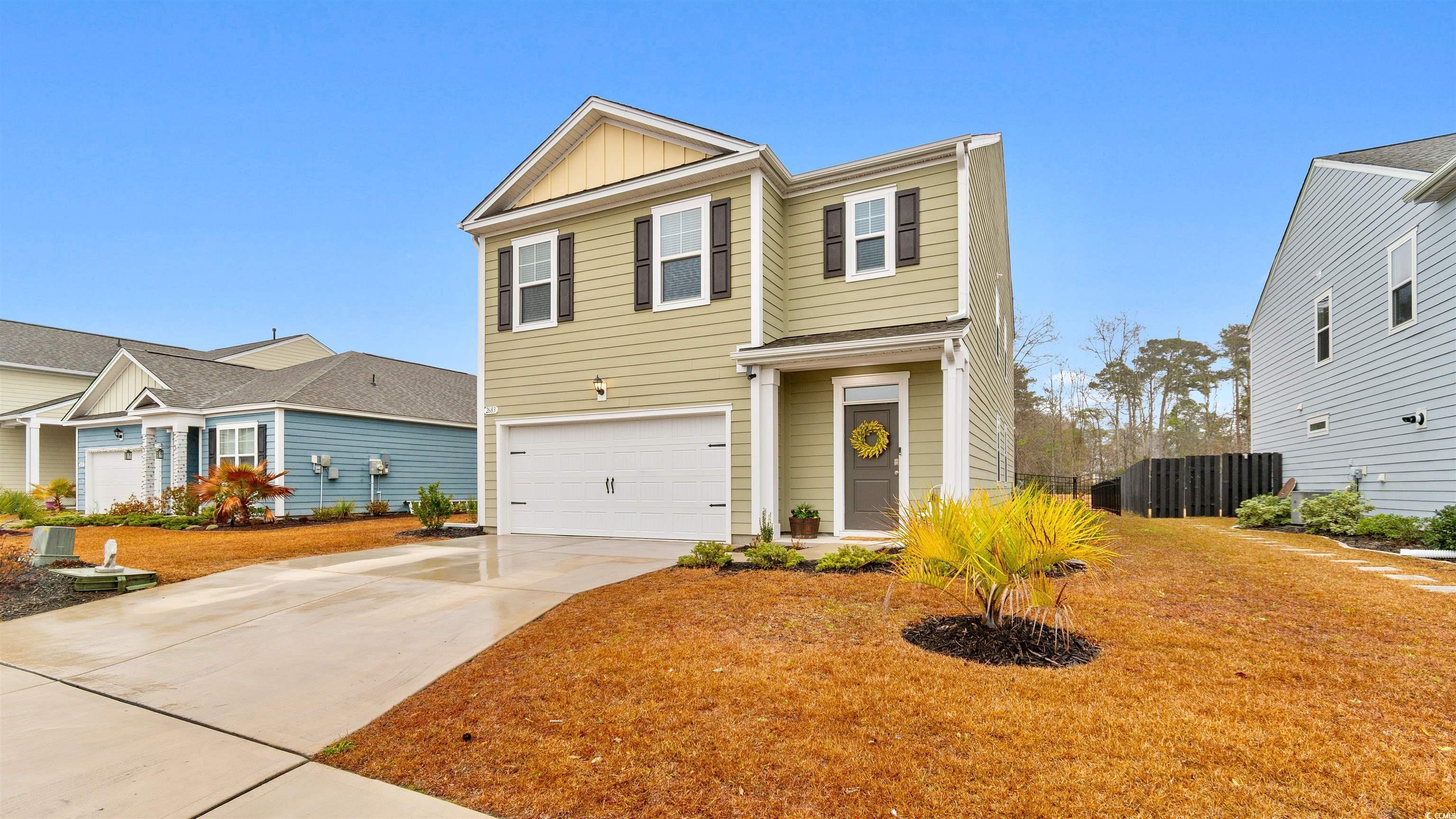Image 1: Traditional home with driveway, an attached garage