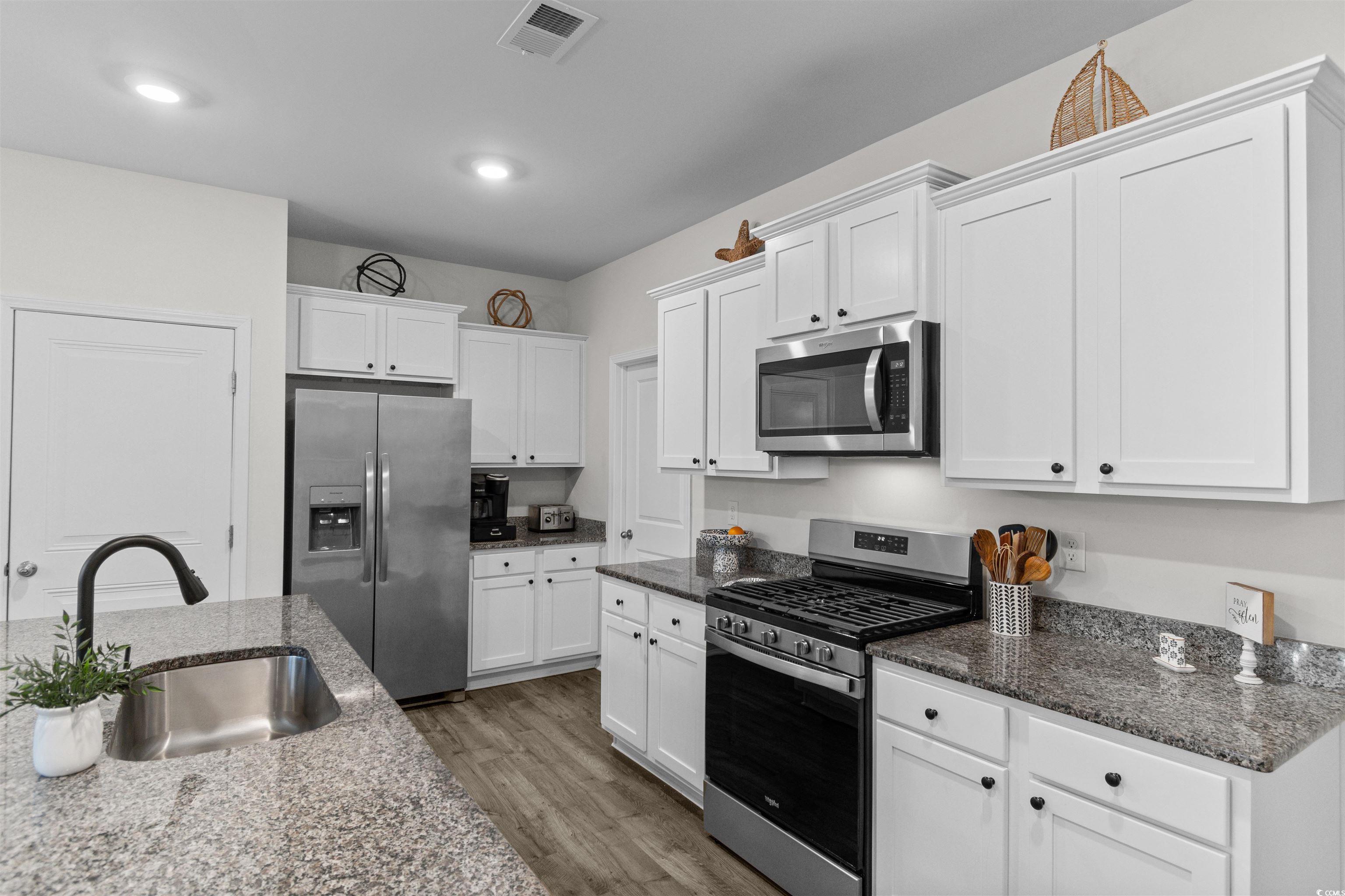 Image 4: Kitchen featuring stainless steel appliances, whit