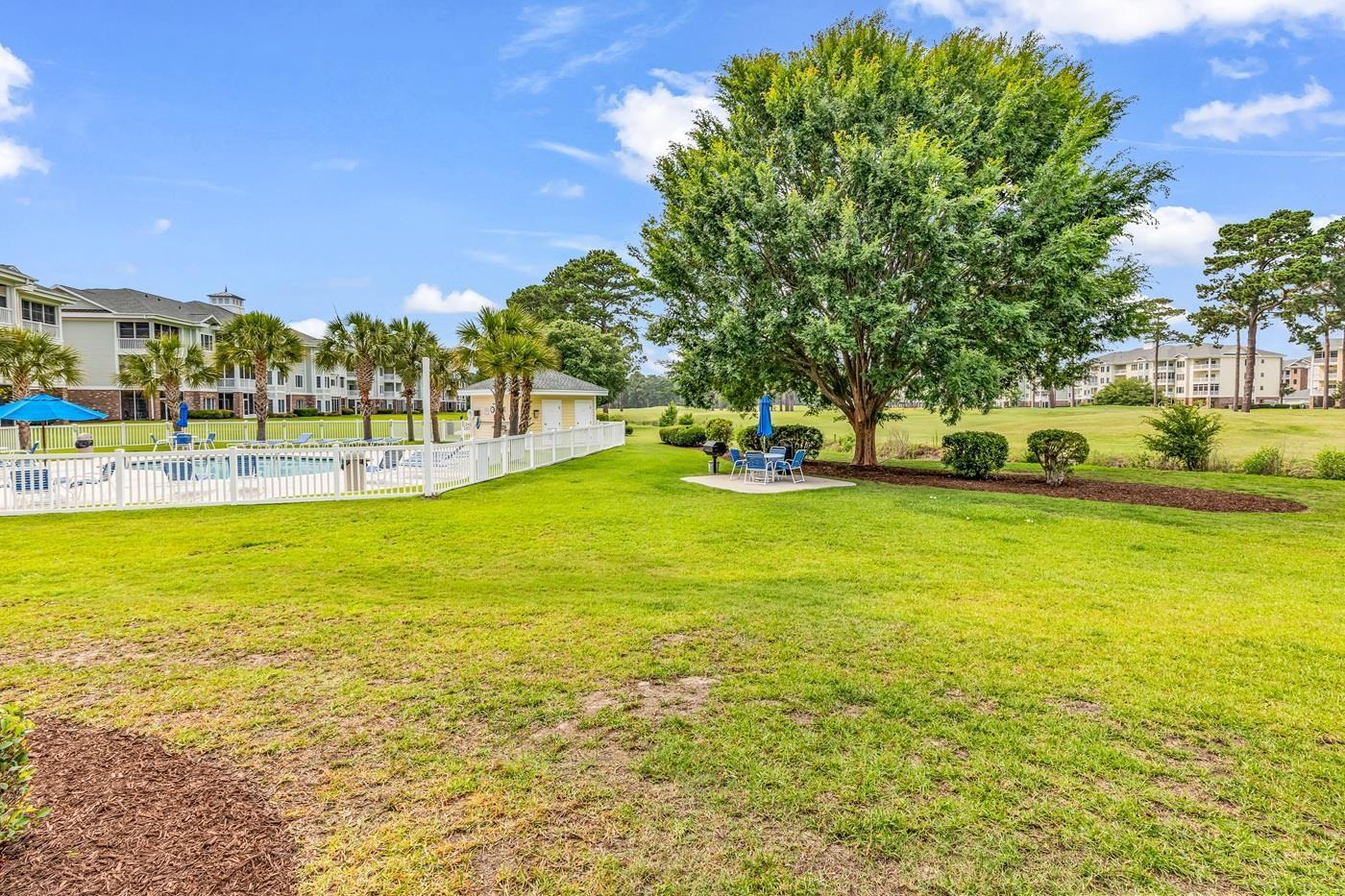 Image 2: View of yard with a patio and a community pool Image 2: View of yard with a patio and a community pool