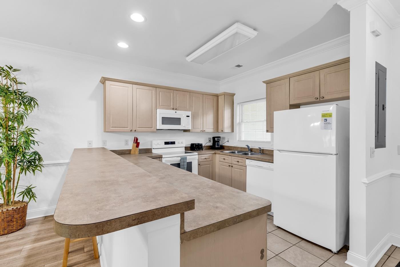 Image 4: Kitchen featuring white appliances, a breakfast ba Image 4: Kitchen featuring white appliances, a breakfast ba