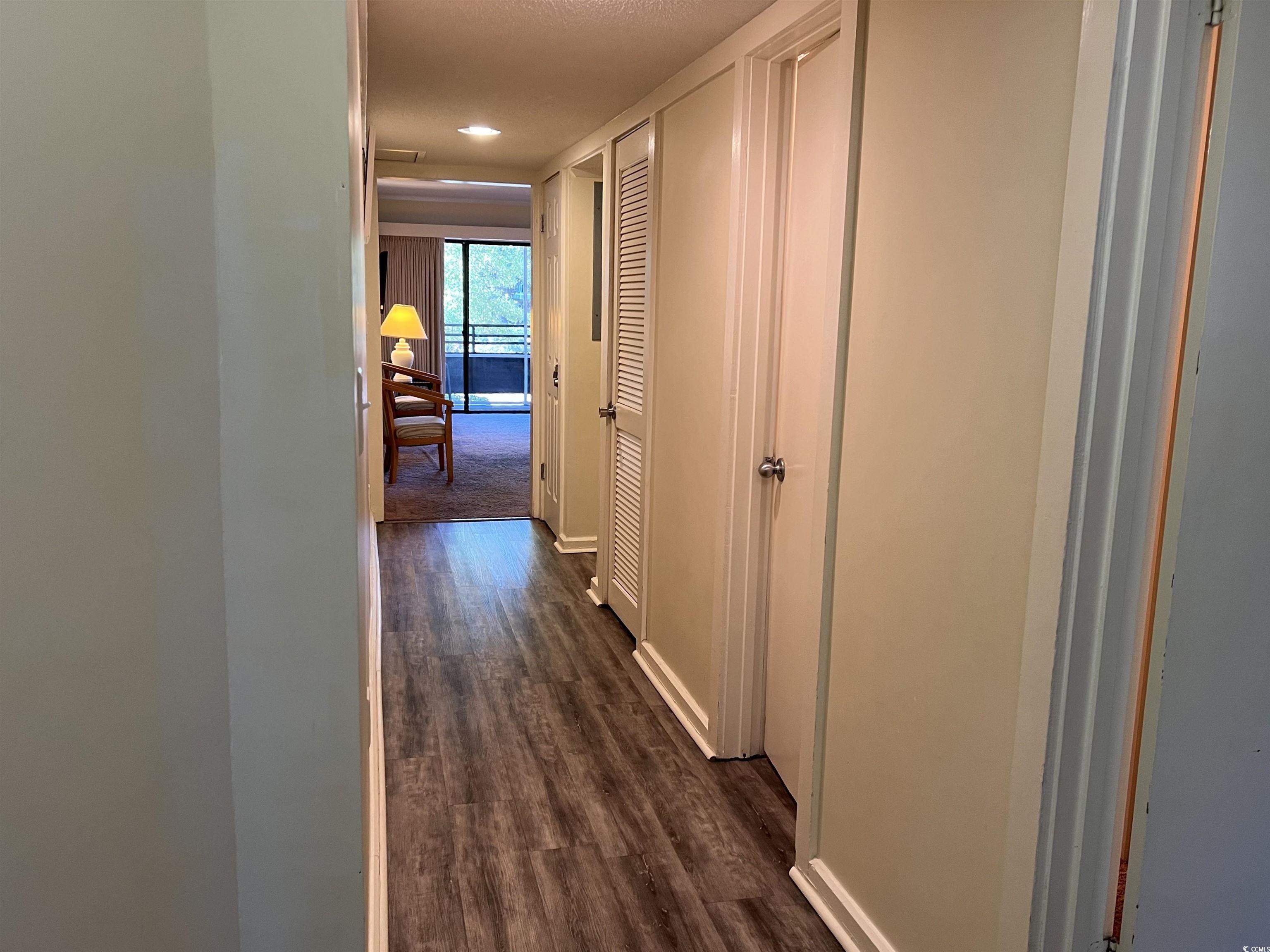 Image 2: Hall with dark wood-type flooring and baseboards Image 2: Hall with dark wood-type flooring and baseboards