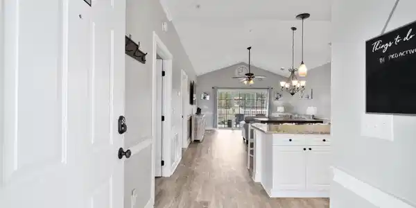 Image 2: Corridor featuring a chandelier, vaulted ceiling, Image 2: Corridor featuring a chandelier, vaulted ceiling,