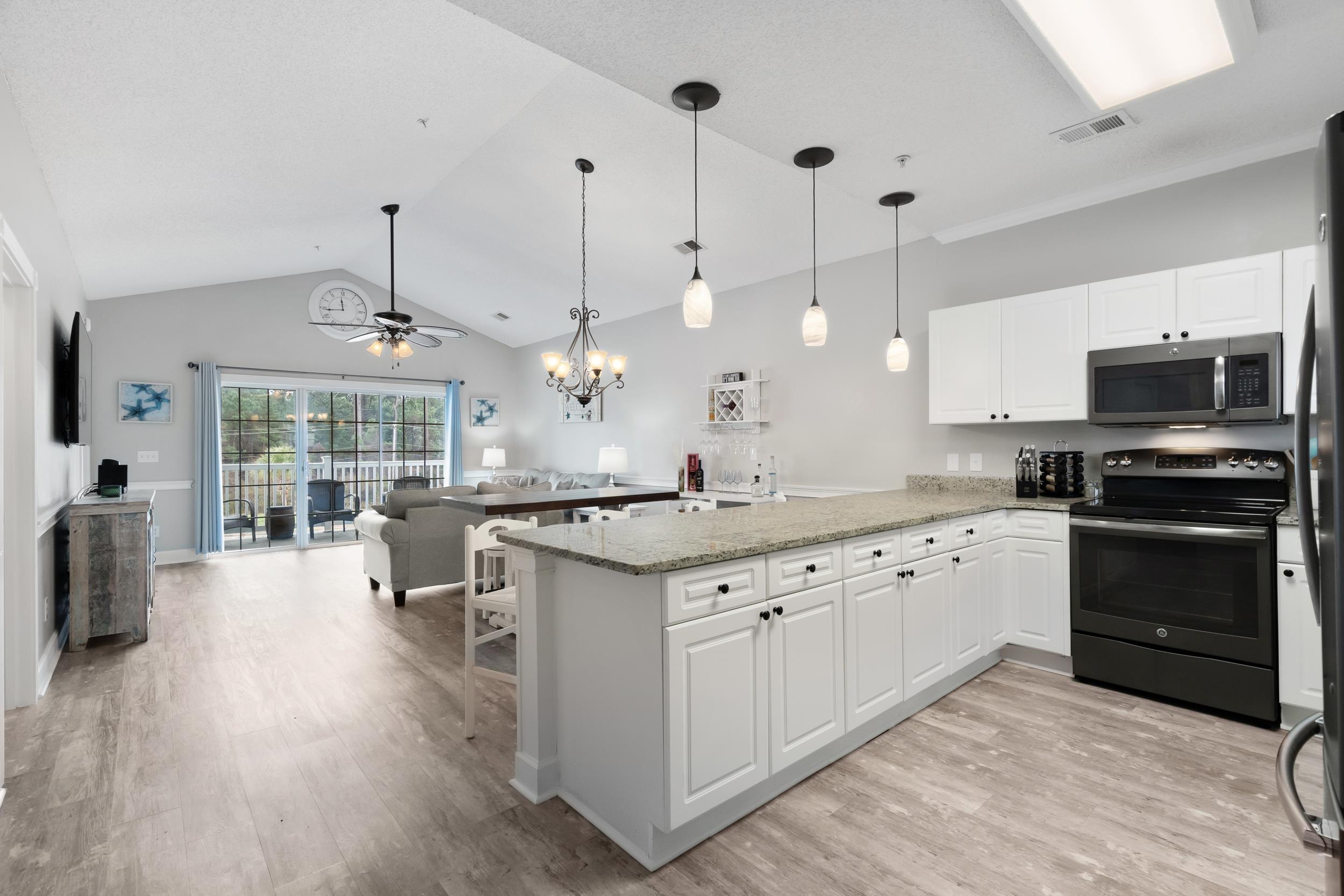 Image 3: Kitchen featuring black appliances, a chandelier, Image 3: Kitchen featuring black appliances, a chandelier,