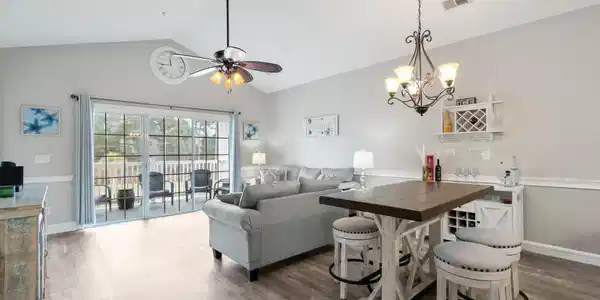 Image 4: Living area with a chandelier, dark wood-type floo Image 4: Living area with a chandelier, dark wood-type floo
